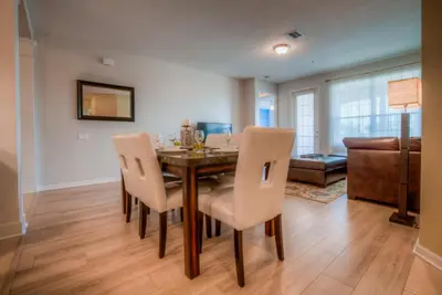 a dining room with a table and chairs at Beautiful LAKEVIEW Deluxe Condo Near Theme Parks in Orlando