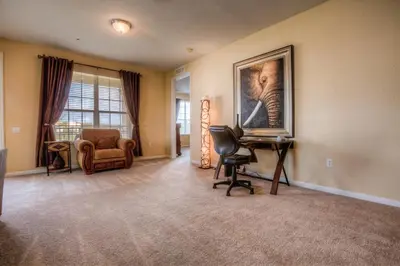 a living room with a desk and a picture of an elephant at Luxurious Condo wPrivate Balcony AMAZING View in Orlando