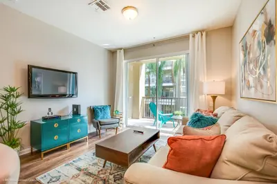 a living room with a couch and a tv at Gorgeous Vista Cay Condo, next to Resort Clubhouse in Orlando