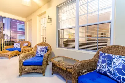 a room with wicker chairs and a window at Spacious Condo in Vista Cay Resort LUXURY AWAITS in Orlando