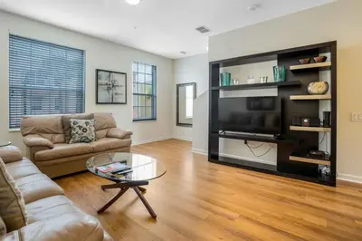 a living room with a couch and a large television at 3-Story Townhome at Vista Cay Resort in Orlando