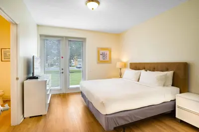a bedroom with a large white bed and a window at 3-Story Townhome at Vista Cay Resort in Orlando