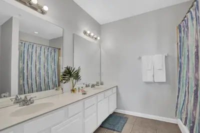 a bathroom with a sink and a large mirror at NEWLY RENOVATED Townhome, Near Universal & I-Drive in Orlando