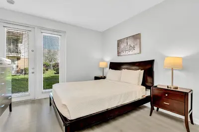 a white bedroom with a bed and a window at NEWLY RENOVATED Townhome, Near Universal & I-Drive in Orlando
