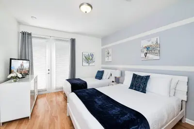 a bedroom with two beds and a television in it at Beautiful Newly Updated Townhome Sleeps 10 in Orlando