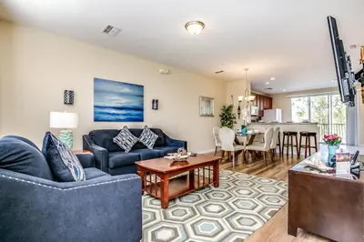 a living room with two blue couches and a table at Spacious Vista Cay Townhome Newly Furnished in Orlando
