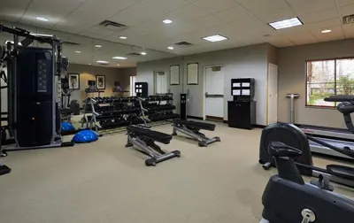 a gym with a lot of treadmills and machines at Staybridge Suites Orlando South by IHG in Orlando
