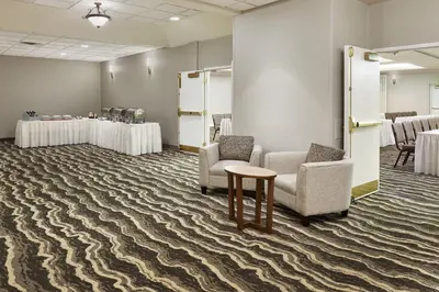 a waiting room with two chairs and a table at Staybridge Suites Orlando South by IHG in Orlando