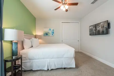 a bedroom with a white bed and a ceiling fan at Splendid Home With Private Pool, Loft Area, Waterpark & Resort Access Near Disney At Encore Resort - 7619Br in Kissimmee