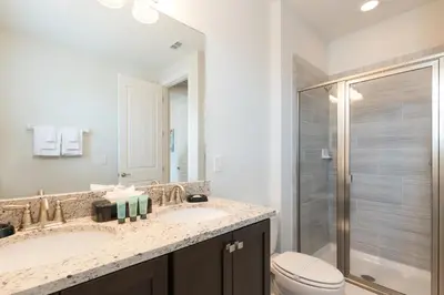 a bathroom with a sink and a toilet and a shower at Splendid Home With Private Pool, Loft Area, Waterpark & Resort Access Near Disney At Encore Resort - 7619Br in Kissimmee