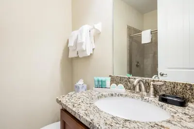 a bathroom with a sink and a toilet at Elegant Home Near Disney With Private Pool And Waterpark & Resort Access At Encore Resorts Reunion - 621La in Kissimmee