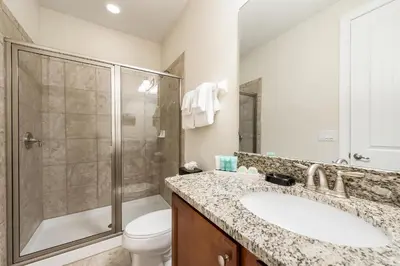 a bathroom with a sink and a shower and a toilet at Elegant Home Near Disney With Private Pool And Waterpark & Resort Access At Encore Resorts Reunion - 621La in Kissimmee
