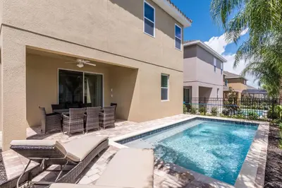 a villa with a swimming pool and a house at Vibrant Home Near Disney With Private Pool, Themed Rooms And Waterpark & Resort Access At Encore Resorts Reunion - 401No in Kissimmee