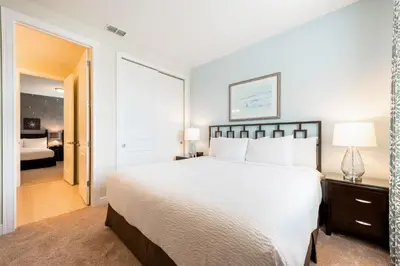 a bedroom with a large white bed and a doorway at Vibrant Home Near Disney With Private Pool, Themed Rooms And Waterpark & Resort Access At Encore Resorts Reunion - 401No in Kissimmee