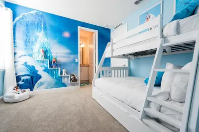 a childs room with two bunk beds with a snowman mural at Exquisite Home With Themed Rooms, Theater Near Disney With Waterpark & Resort Access At Encore Resort - 7736Ff in Orlando