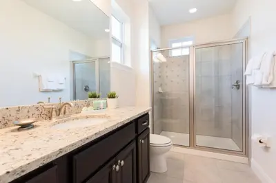 a bathroom with a shower and a sink and a toilet at Grand Home Near Disney With Private Pool, Media And Themed Rooms With Waterpark & Resort Access At Encore Resorts Reunion - 360Bu in Kissimmee