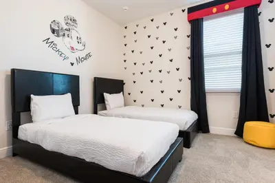 two beds in a room with black and white at Grand Home Near Disney With Private Pool, Media And Themed Rooms With Waterpark & Resort Access At Encore Resorts Reunion - 360Bu in Kissimmee