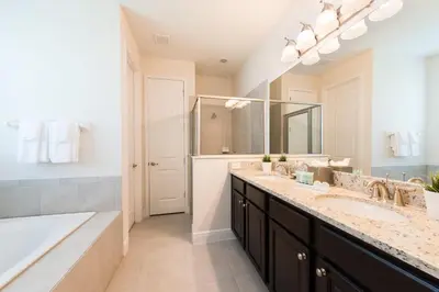 a bathroom with two sinks and a large mirror at Grand Home Near Disney With Private Pool, Media And Themed Rooms With Waterpark & Resort Access At Encore Resorts Reunion - 360Bu in Kissimmee