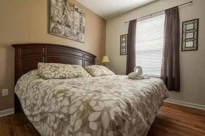 a bedroom with a bed with a teddy bear on it at Vista Cay Inn in Orlando