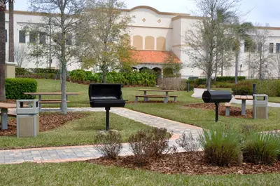a park with benches and a building in the background at Vista Cay Inn in Orlando