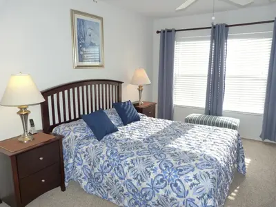 a bedroom with a bed with a blue and white comforter at SPECTACULAR Home And Resort! Near Dis, Splash Park, Lake With Boats, Pool, This Home And Resort Has It ALL! Low Rates Too! in Kissimmee