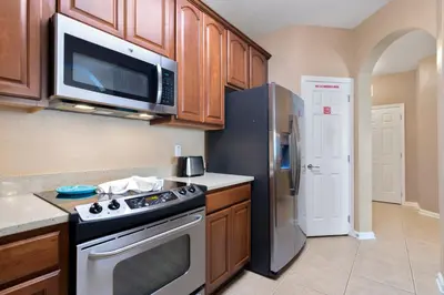 a kitchen with a stove and a microwave and a refrigerator at Orlando Resort Rentals at Universal Boulevard in Orlando