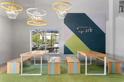 a rendering of a restaurant with benches and tables at Spark by Hilton Orlando near SeaWorld in Orlando
