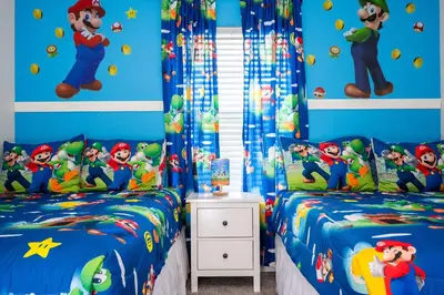 a childs room with two twin beds with super mario bedroom at Family Friendly Four Bedrooms w/ Pool 4896 in Kissimmee