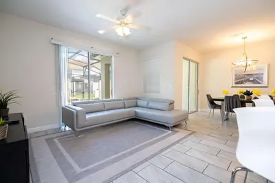 a living room with a couch and a table at Family Friendly Four Bedrooms w/ Pool 4896 in Kissimmee