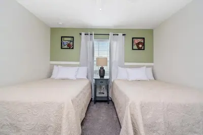 two beds in a room with green walls at Four Bedrooms close to Disney w Pool 4898 in Kissimmee