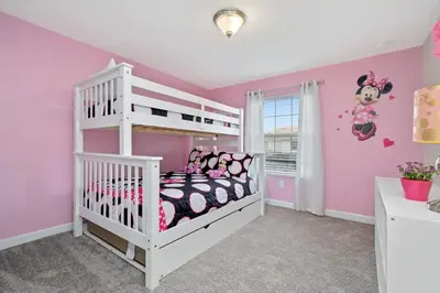 a childs bedroom with a white bunk bed and pink walls at Four Bedrooms close to Disney w Pool 4898 in Kissimmee