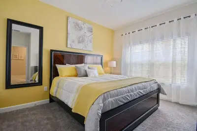 a bedroom with a large bed and a large window at Four Bedrooms close to Disney w Pool 4898 in Kissimmee