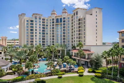 an aerial view of the resort with a pool and palm trees at Wyndham Grand Orlando Resort Bonnet Creek in Orlando