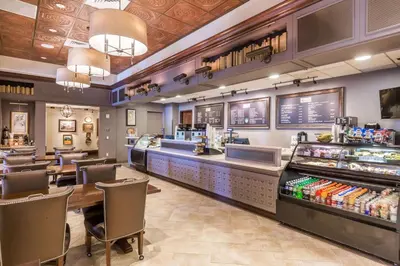 a fast food restaurant with a counter and tables and chairs at Wyndham Grand Orlando Resort Bonnet Creek in Orlando