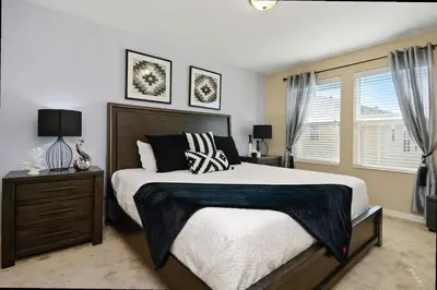 a bedroom with a large bed and a window at Family Friendly 4 Bedroom Close to Disney 5148 in Kissimmee