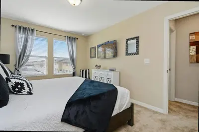 a bedroom with a large bed and a window at Family Friendly 4 Bedroom Close to Disney 5148 in Kissimmee