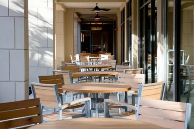 a row of tables and chairs in a restaurant at SpringHill Suites by Marriott Orlando Theme Parks Lake Buena Vista in Orlando