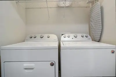 two white appliances sitting next to each other in a kitchen at Family Friendly Four Bedrooms 5145 in Kissimmee