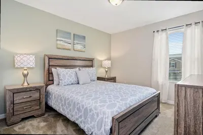 a bedroom with a bed and a window at Family Friendly Four Bedrooms 5145 in Kissimmee