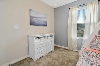 a bedroom with a white dresser and a bed at Family Friendly Four Bedrooms 5145 in Kissimmee