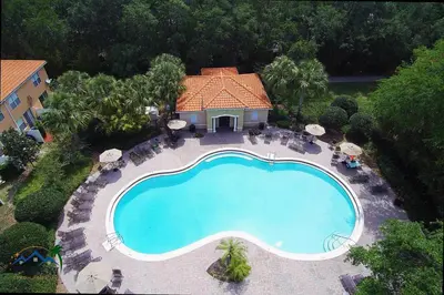 an overhead view of a swimming pool in front of a house at Family Friendly Four Bedrooms 5145 in Kissimmee