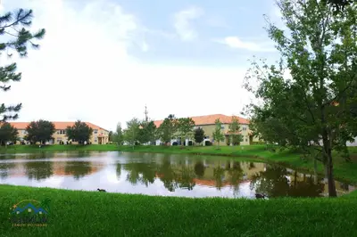 a pond in front of a building at Family Friendly Four Bedrooms 5145 in Kissimmee