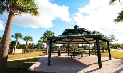 a gazebo in a park with a palm tree at Family Friendly Four Bedrooms 5147A in Kissimmee