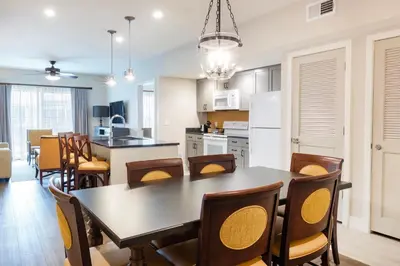 a kitchen and dining room with a table and chairs at WorldMark Orlando Kingstown Reef in Orlando