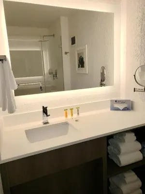 a bathroom with a sink and a large mirror at Holiday Inn Resort Kissimmee by the Parks by IHG in Orlando
