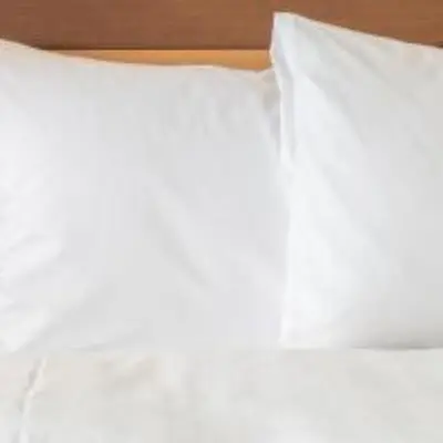 a close up of a white pillow on a bed at Holiday Inn Resort Kissimmee by the Parks by IHG in Orlando