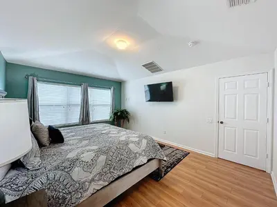 a bedroom with a bed and a tv on a wall at Disney World Vacation.. Luxury 6 BR/4 BA 5 Star Villa in Orlando