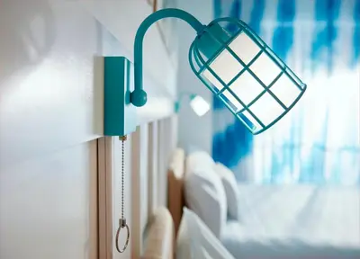a lamp on a wall next to a bed at Universal's Endless Summer Resort - Surfside Inn and Suites in Orlando