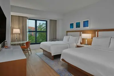a hotel room with two beds and a large window at Walt Disney World Swan in Orlando