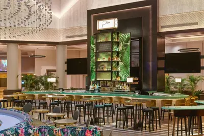 a restaurant with tables and chairs and a bar at Walt Disney World Swan in Orlando
